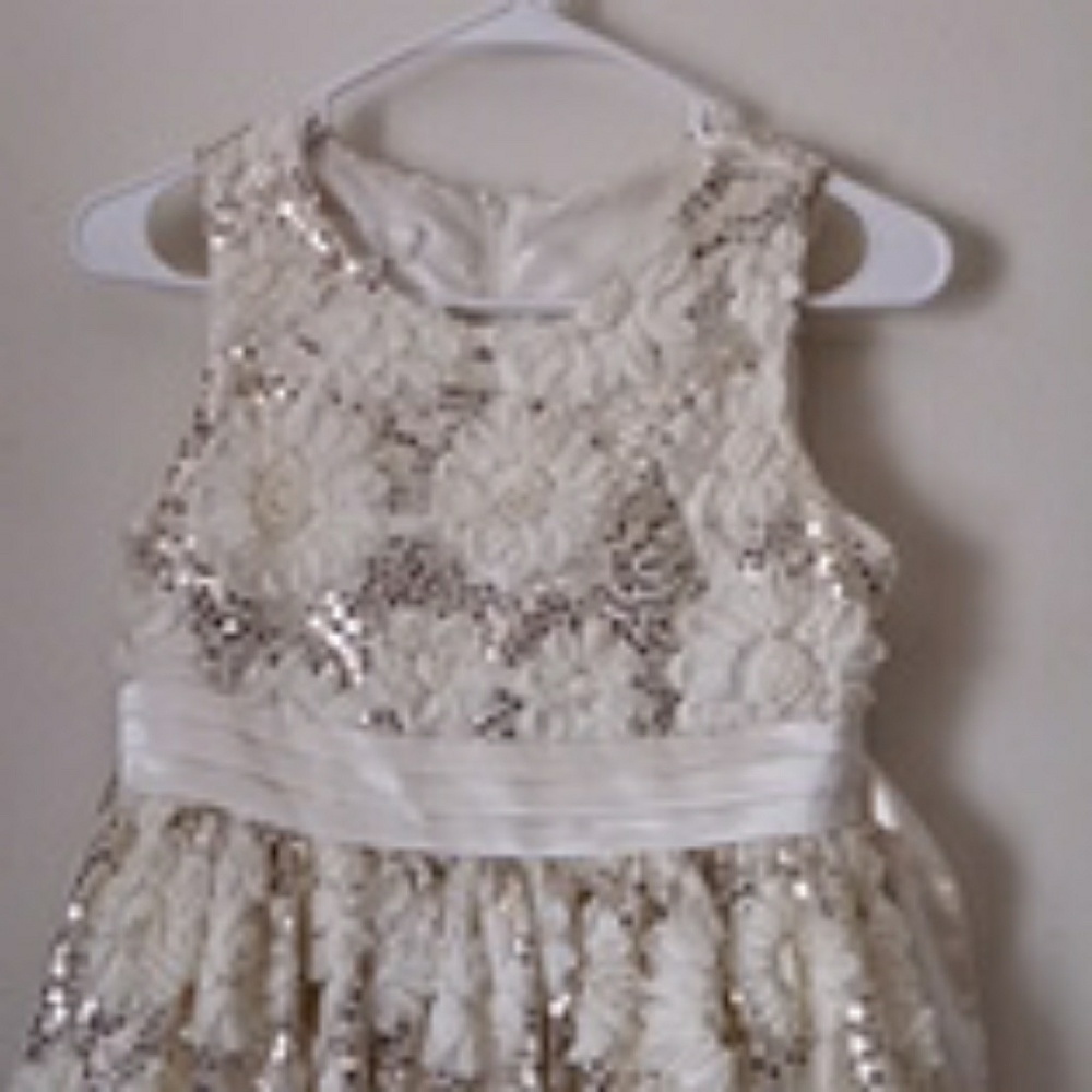 A white, floral, and shimmery dress